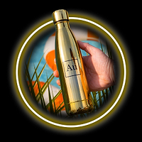 Hand holding a gold water bottle with Au symbol, surrounded by green leaves and a blue and orange background
