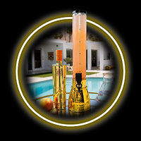 Au Vodka Juicy Peach bottle and drink dispenser on a table by a swimming pool