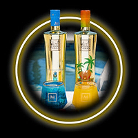 Two bottles of Ali Limoncello and two candles, one blue and one yellow, on a dark background