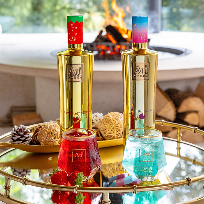 Au Vodka Strawberry Burst and Bubblegum bottle bundle with matching cocktails on a gold tray
