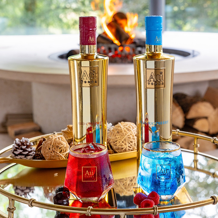 Au Vodka Red Cherry and Blue Raspberry bottles with matching cocktails on a gold tray