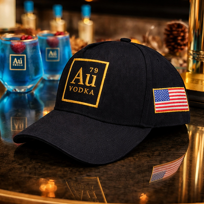 Au Vodka USA black baseball cap with gold logo and American flag patch