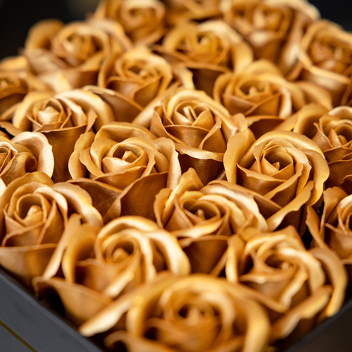 Au Vodka merchandise box filled with metallic gold artificial roses