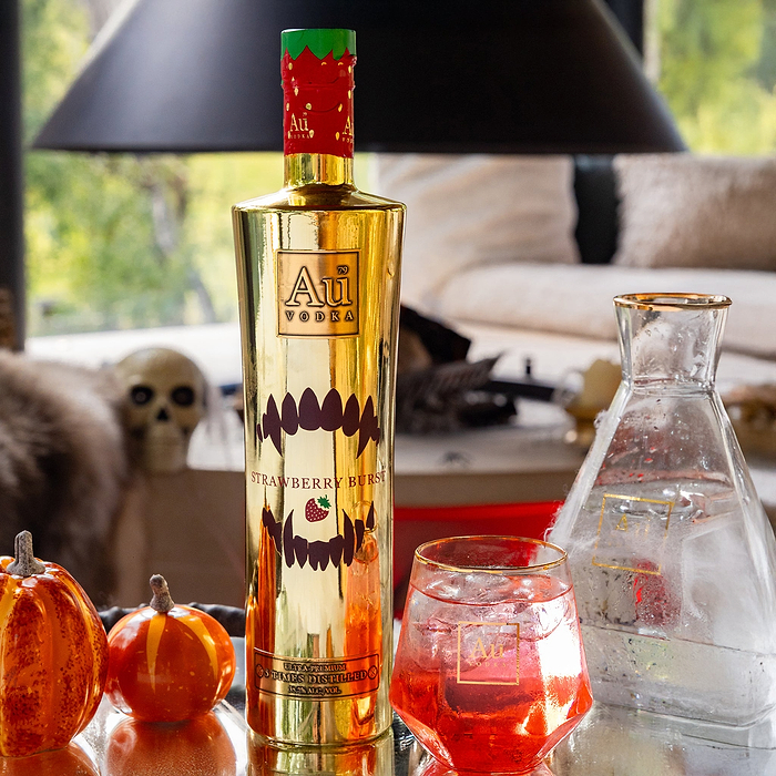 Au Vodka Strawberry Burst Halloween Edition. Next to a Au Branded Glass with Red Liquid.