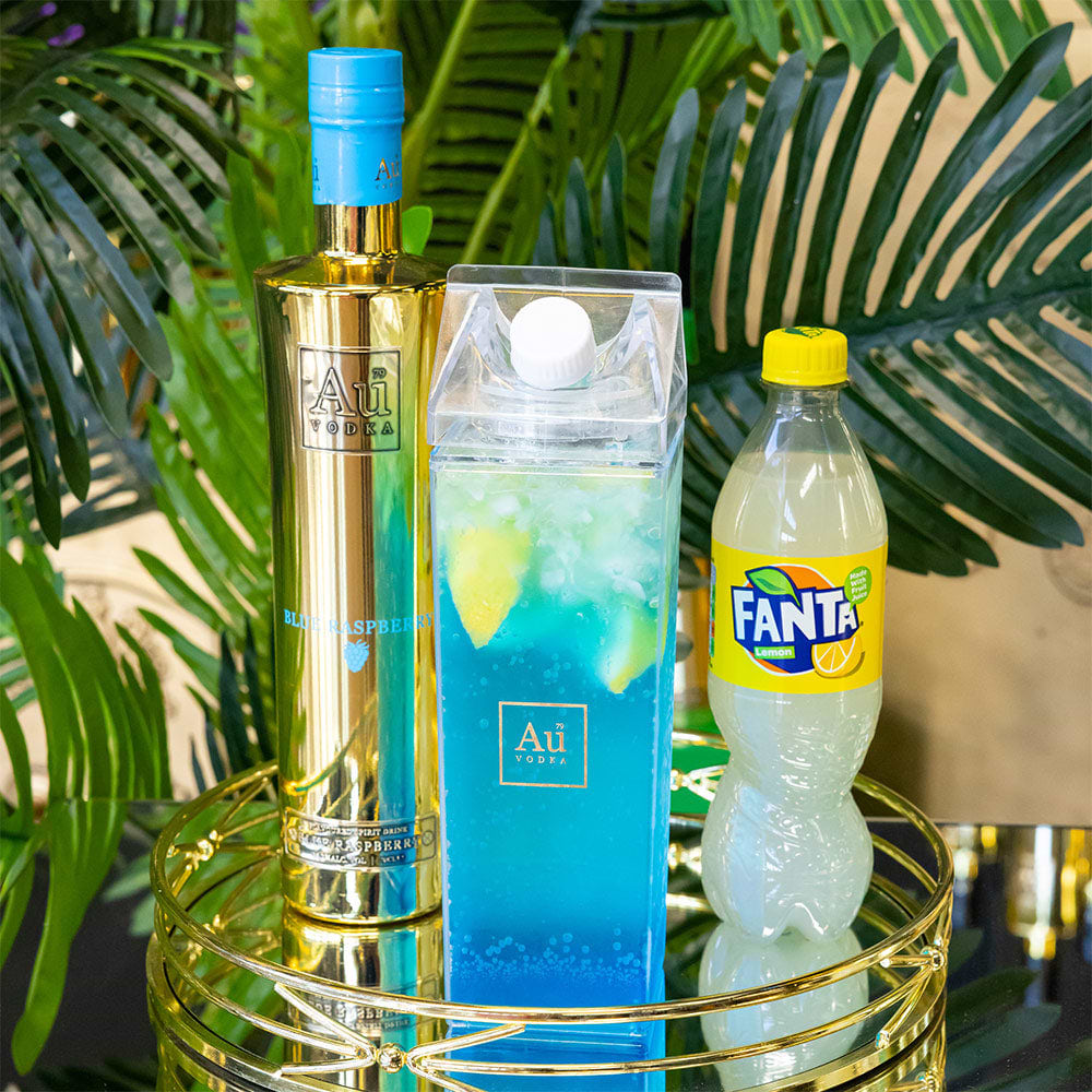 Au Vodka bottle next to a clear carton of blue cocktail and a bottle of Fanta