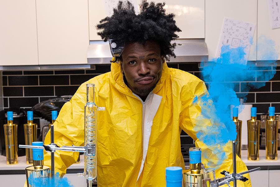 Man in yellow hazmat suit with blue smoke and laboratory equipment