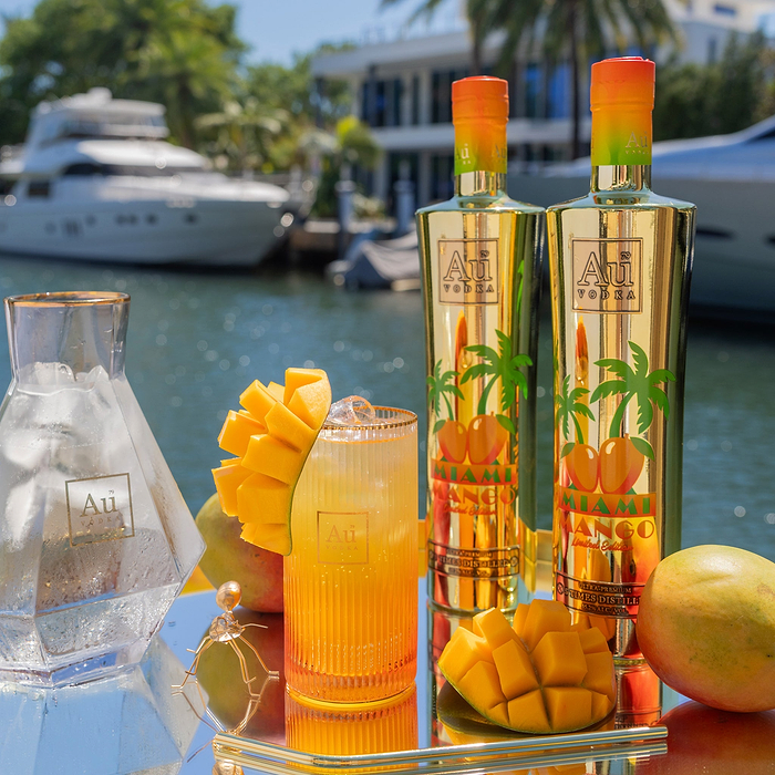 Au Vodka USA Miami Mango Limited Edition bottles and cocktail on a yacht
