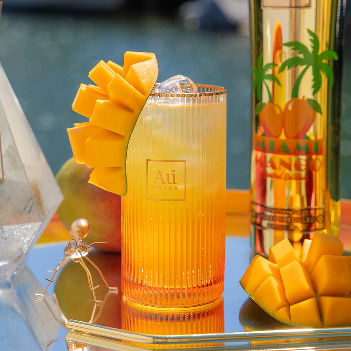 Close up of Au Vodka USA Mango Passion drink with mango garnish