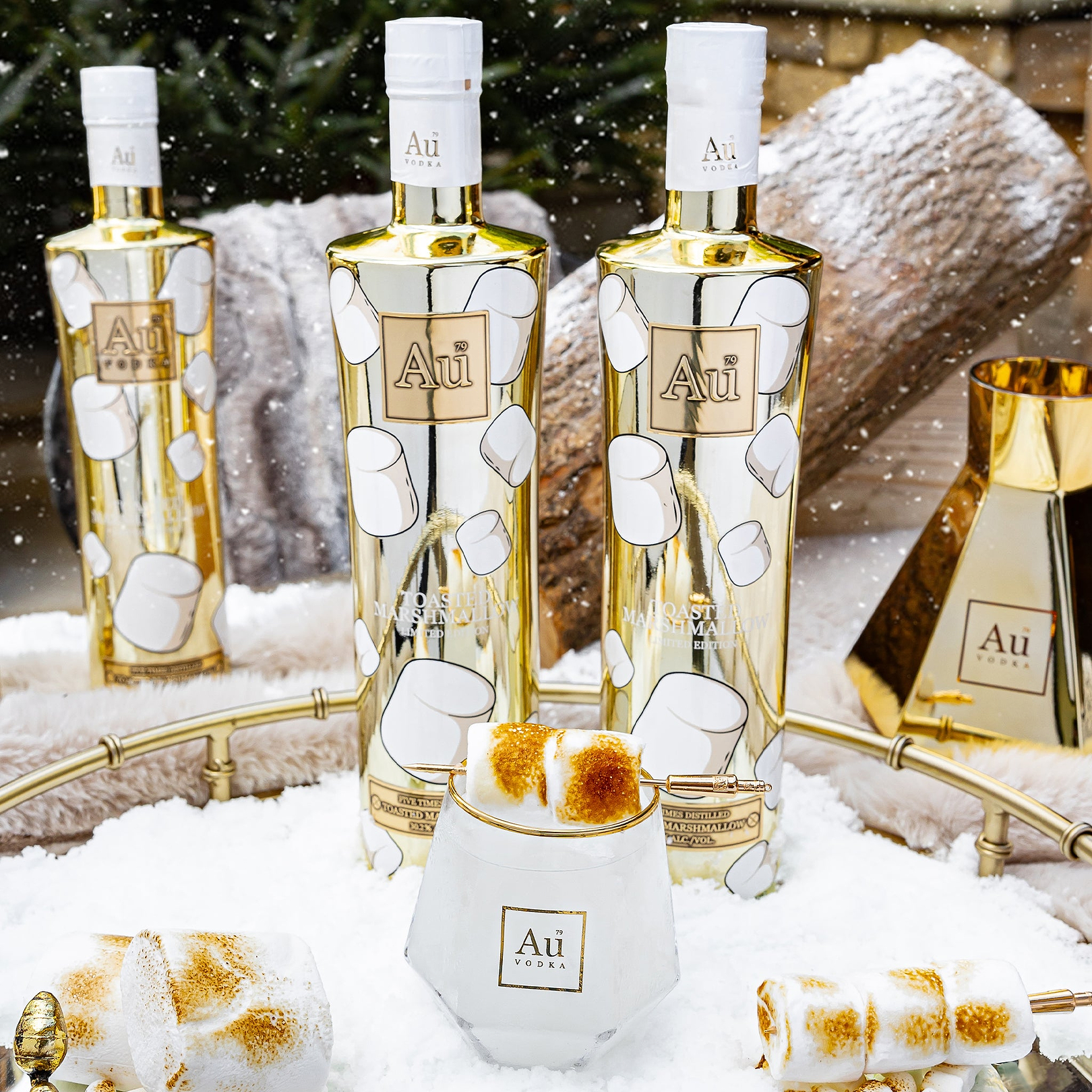 Au Vodka USA Toasted Marshmallow Vodka Bottles with toasted marshmallows in a snowy setting