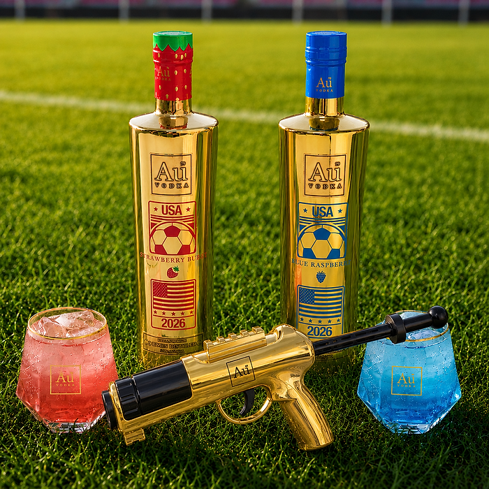 Au Vodka USA Strawberry Burst and Blue Raspberry bottles, gold water gun, and two cocktails on grass