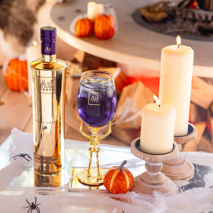 Au Vodka Black Grape bottle and skeleton glass bundle with candles and pumpkins