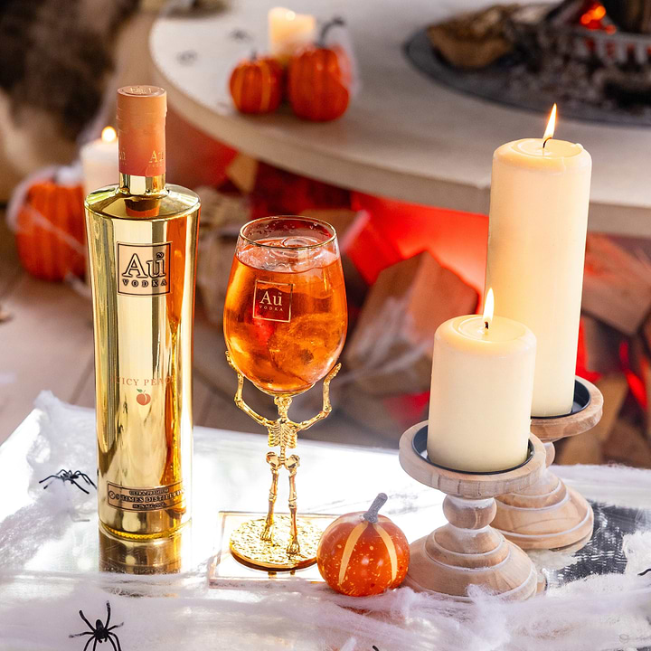 Au Vodka Juicy Peach bottle and skeleton stem glass bundle with candles and Halloween decor