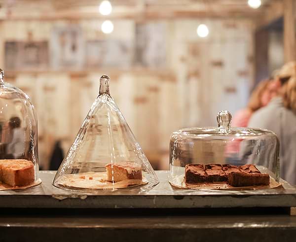 Cakes displayed in large glass domes