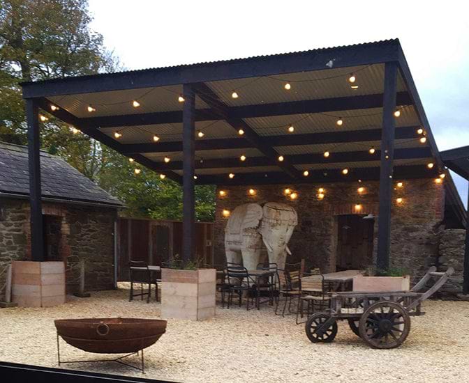 Large wooden elephant in outdoor courtyard