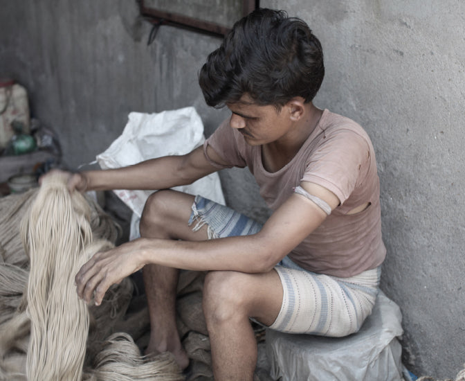 Indian artisan holding natural jute