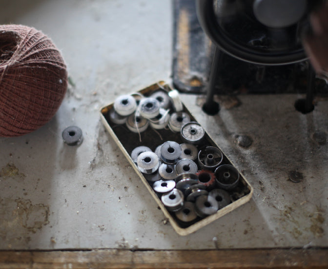Metal bobbins in a tray 