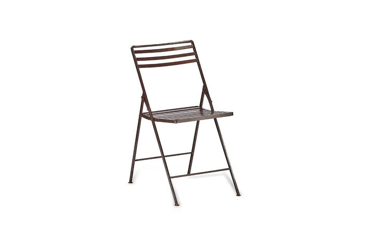 The nkuku Yealme Iron Bistro Chair is shown angled right on a white background. With a simple brown slatted seat and backrest plus thin legs, its lightweight minimalist design suits industrial outdoor settings.