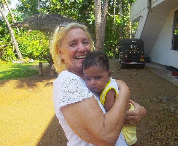 Joy and young baby in her arms