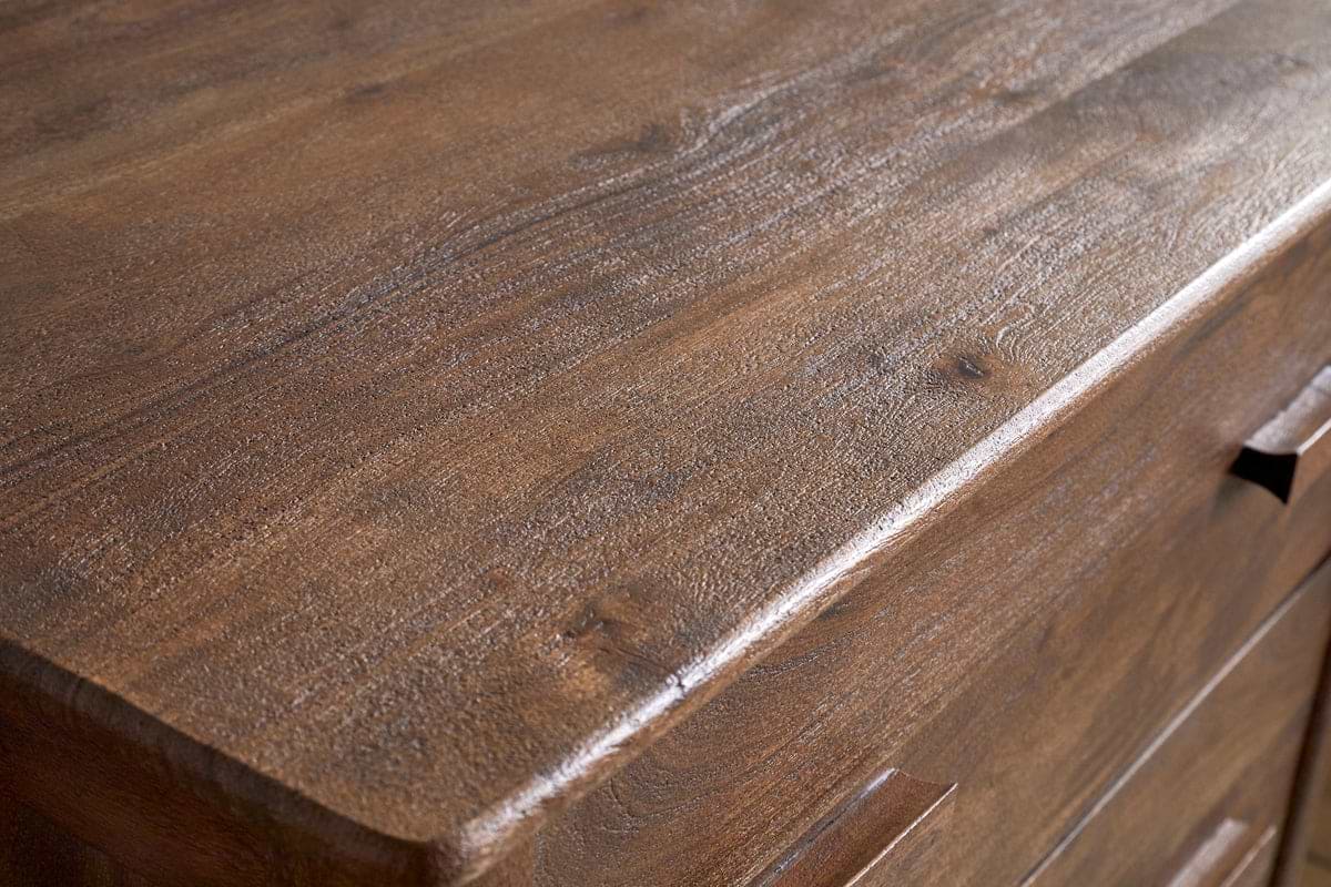 Close-up of the nkuku Anbu Acacia Chest of Drawers in Washed Walnut, showcasing its smooth, polished surface, natural wood grain, and subtle brown tones. Two drawer handles add style to this elegant bedroom storage piece.