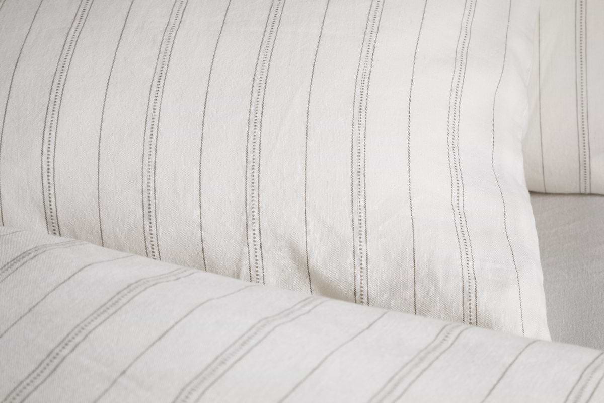 Close-up of nkukus Anta Hemp & Cotton Housewife Pillowcases in sage green, featuring a visible soft texture and slightly wrinkled surface.