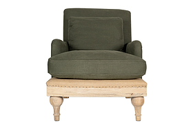 The nkuku Abe Deconstructed Linen Armchair - Olive features linen upholstery, a square backrest, cushioned seat, matching pillow, mango wood frame with decorative studs, and turned wooden legs. Set against a plain white background.
