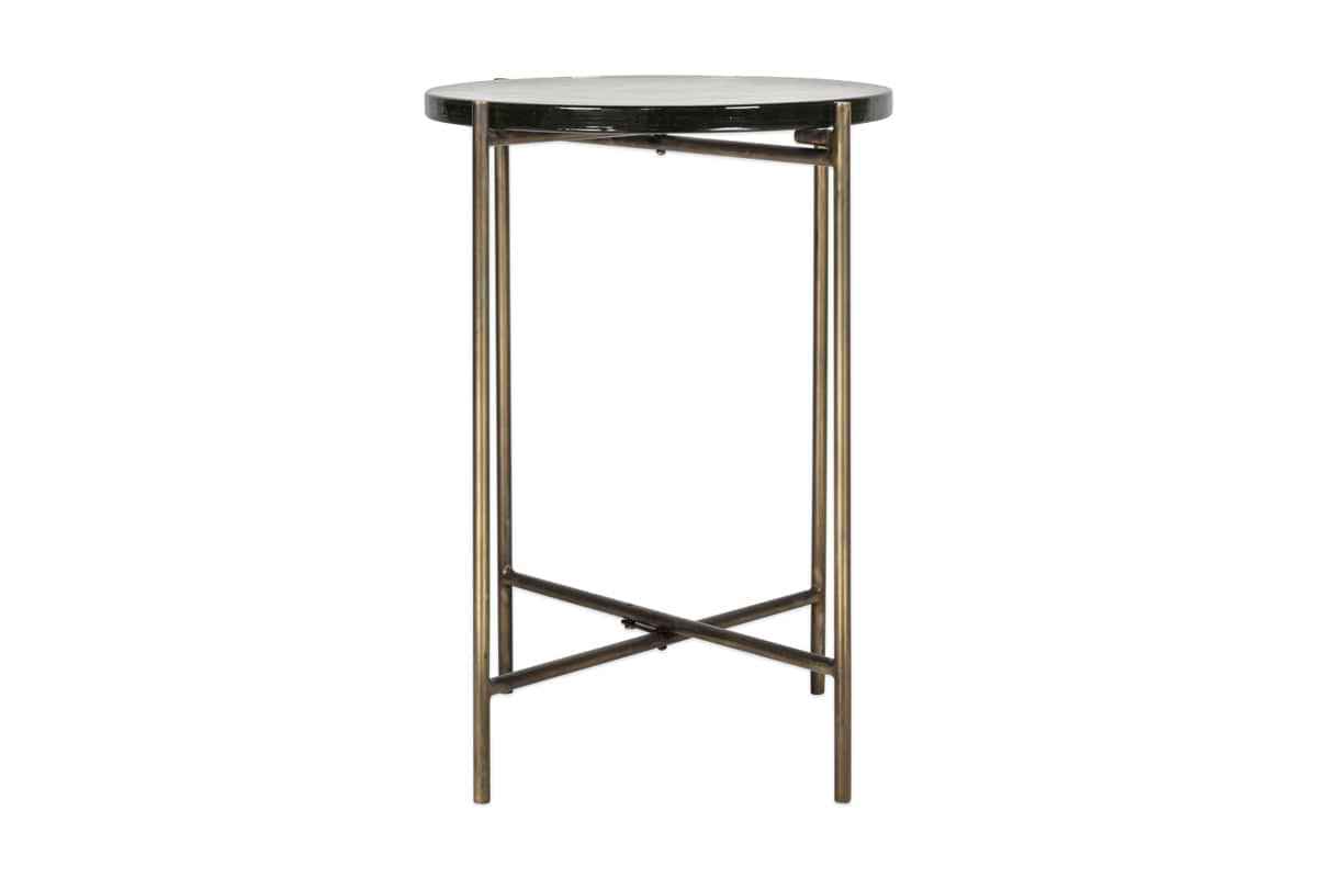 The nkuku Aluva Glass Side Table features a clear glass top with an antique brass-finished metal frame and crossed base.