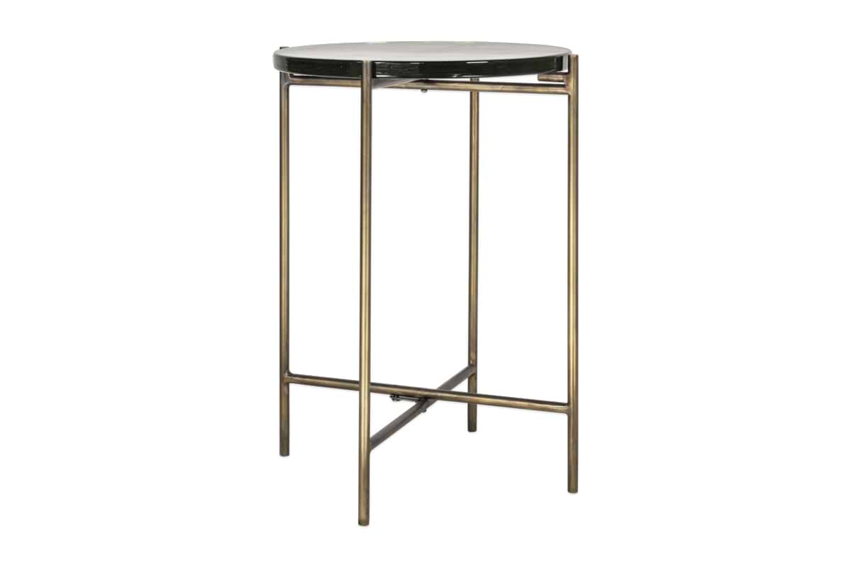 The nkuku Aluva Glass Side Table features a clear, round glass top and a slim antique brass frame. Four straight legs with horizontal base supports create a minimalist, modern look.
