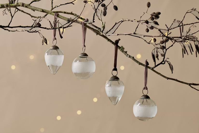 Anara Etched Bauble set of four in clear recycled glass with frosted bands, hanging from velvet ties.