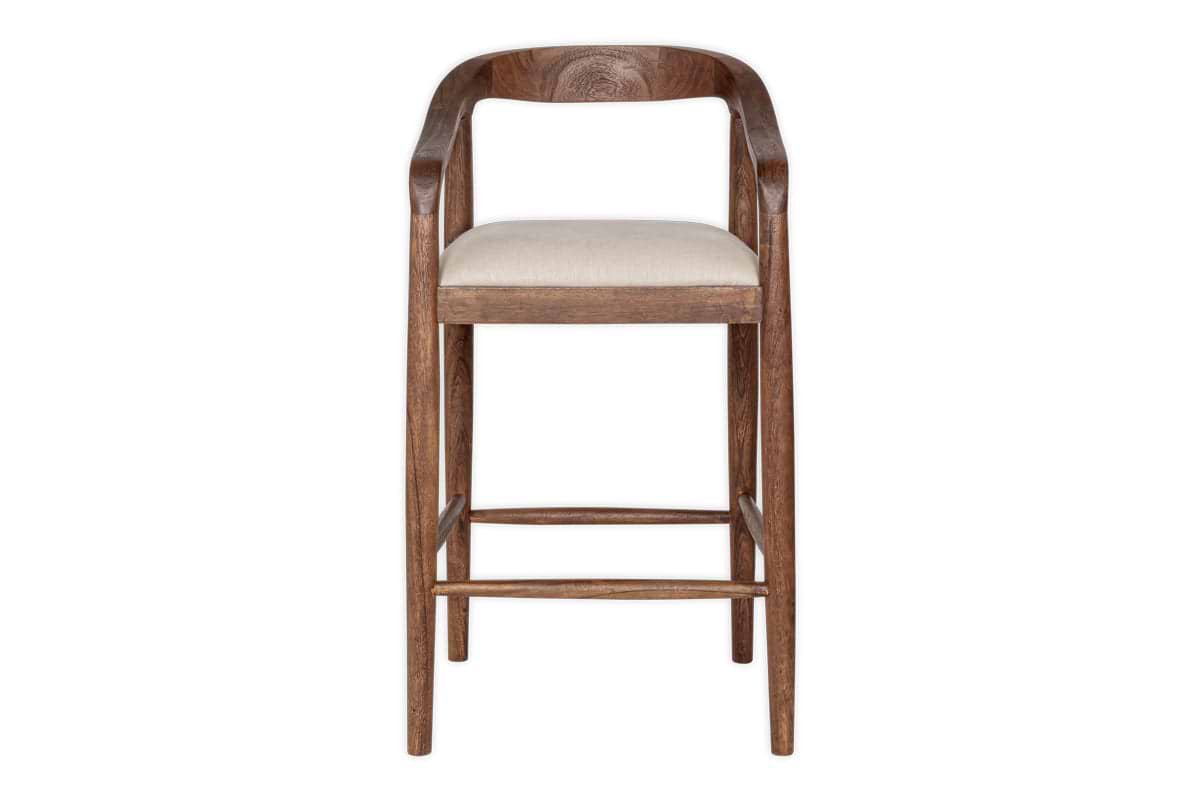 The Anbu Acacia Upholstered Counter Chair by nkuku features a curved backrest, armrests, and a beige seat cushion. Its four straight legs with support bars display a washed walnut finish, shown against a plain white background.