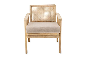 The Atri Mango Wood & Cane Occasional Chair by nkuku features a sustainable mango wood frame, woven cane backrest, beige upholstered cushion, and straight legs for a minimalist modern look. Shown on a plain white background.