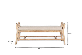 The Avanthi Upholstered Sleigh Bench by nkuku features hand-carved mango wood, a cushioned linen seat, and slatted backrests. Dimensions: 145cm length, 60cm height, 40cm seat height.