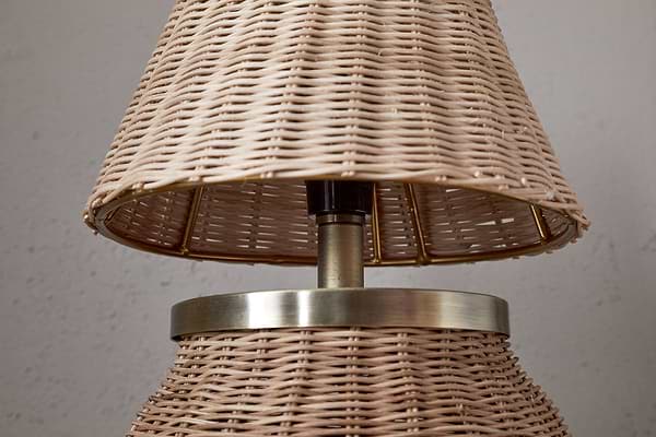 The Cija Rattan Table Lamp by nkuku features a natural woven shade and base, accented with a metallic band and stem—perfect for adding style to any bedside table.