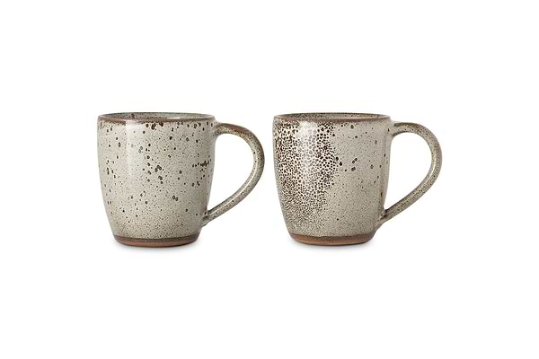 The Cam Large Mug - Mocha (Set of 2) by nkuku is shown against a white background. Each oversized mug features a reactive glaze with an earthy texture, rich brown rim, and handcrafted charm.