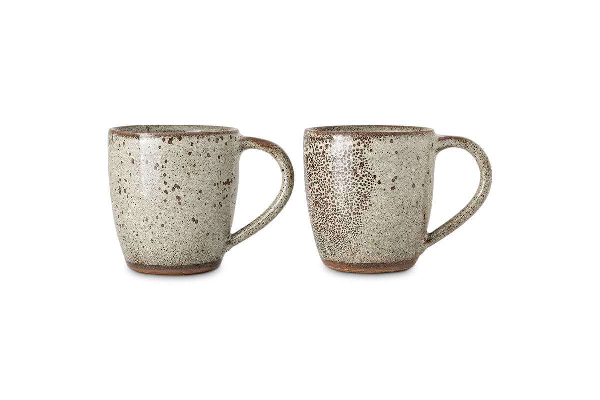 The Cam Large Mug - Mocha (Set of 2) by nkuku is shown against a white background. Each oversized mug features a reactive glaze with an earthy texture, rich brown rim, and handcrafted charm.
