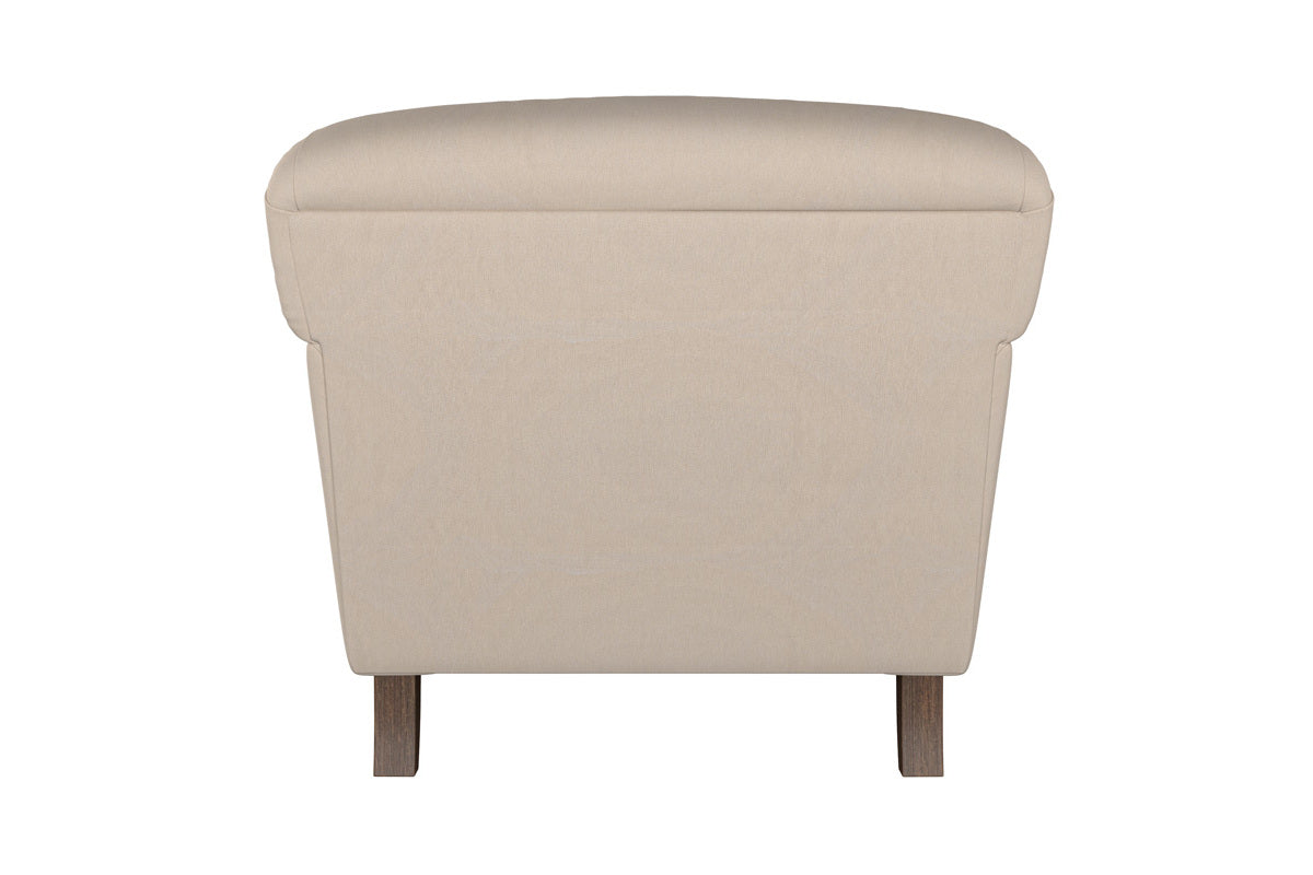 A beige Brera Linen Espresso Deni Large Corner Sofa by Nkuku is viewed from the back, showcasing its plush, rounded backrest and straight sides. Crafted with British quality in mind, the sofa features two short, rectangular wooden legs visible at the base. The background is plain white.
