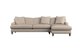 The Deni Large Corner Sofa by Nkuku, in Brera Linen Pebble, features three seat cushions, three matching back pillows, and a right-side chaise lounge. Upholstered in linen and set on short, dark wooden legs, this sofa boasts a clean, modern design against a white background.