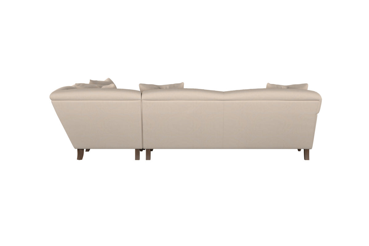 The Deni Large Corner Sofa by Nkuku, shown from the back in Brera Linen Sage, features refined yet relaxed linen upholstery. This spacious two-piece sectional has cushioned backrests and two visible back pillows for comfort. Its short, slightly tapered wooden legs—along with a central support leg where the sections join—enhance its understated British quality. Set against a white, uncluttered background, this sofa’s design is both subtle and sophisticated.