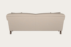 The Deni Large Corner Sofa - Brera Linen Smoke by Nkuku is shown from the back, highlighting its renowned British craftsmanship. This modern, minimal design features two back cushions and two visible wooden legs, upholstered in light linen fabric with clean lines. The sofa stands out against a plain, off-white background.
