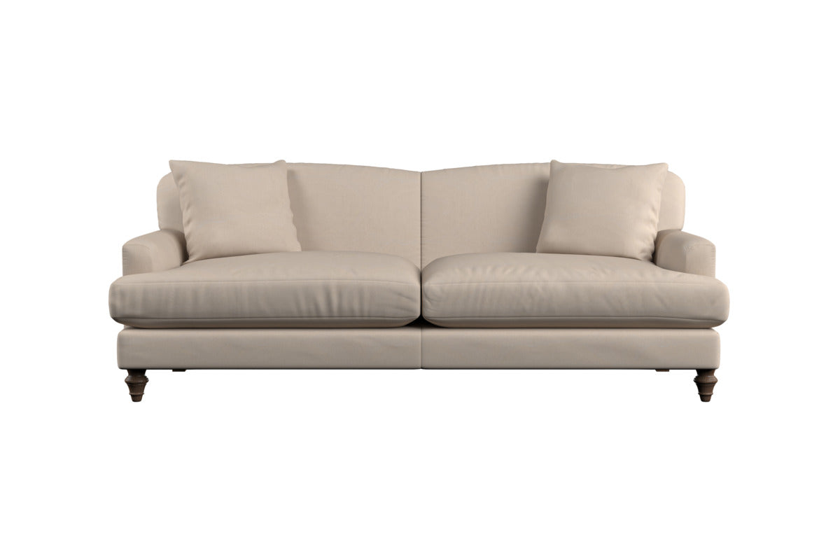 Shown against a white background, the Nkuku Deni Large Corner Sofa in Brera Linen Smoke features elegant linen upholstery in a soft beige-grey tone. Designed with two spacious seat cushions, two plush back cushions, and two matching throw pillows, this upholstered sofa is supported by dark wooden legs and showcases gently rounded arms for a classic yet comfortable look that reflects Nkuku's timeless British craftsmanship.