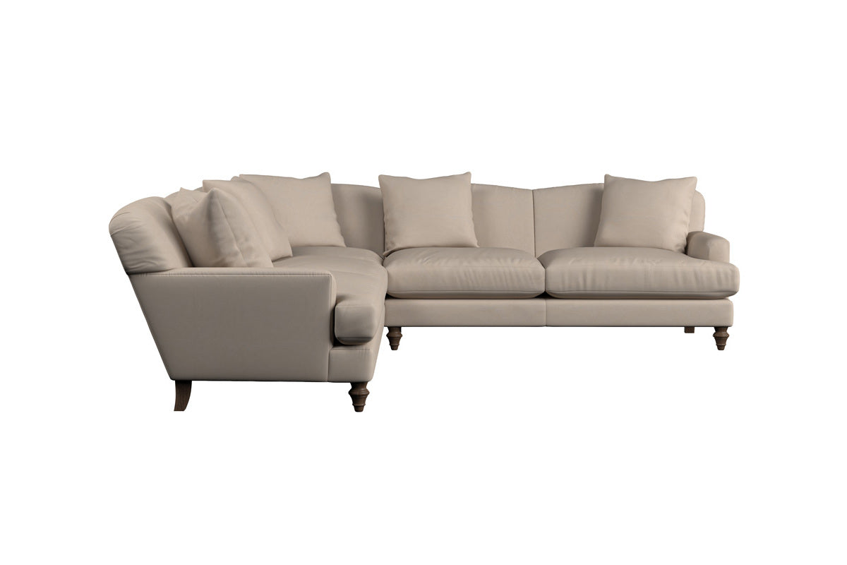 A large charcoal footstool, the Deni by Nkuku, handcrafted in luxurious Brera linen and featuring a plush, inviting appearance with four round wooden legs. Set against a white background, this versatile piece offers timeless style and comfort.