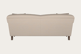 A rear view of the Nkuku Deni Large Sofa in Recycled Cotton Natural showcases its smooth, beige upholstery, with two seat back cushions subtly visible above. The modern design is complemented by four wooden legs and exemplifies British quality furniture, set against a plain off-white background.
