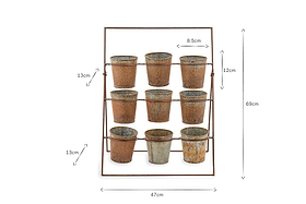 The nkuku Abari Planter Stand holds nine aged zinc pots in three rows. Measuring 69 cm tall and 47 cm wide, its rustic, distressed finish makes it ideal vintage-style garden decor.