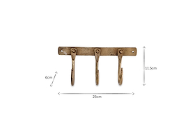 The nkuku Kuna Iron Hooks - Antique Brass is a brass-colored hook rack with three iron hooks on a horizontal bar, perfect for organizing small items. Dimensions: 23cm W x 11.5cm H x 6cm D.