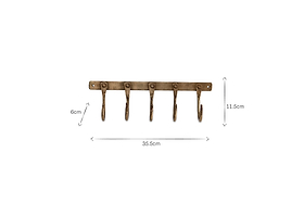 The nkuku Kuna Iron Hooks - Antique Brass features five antique brass-finished hooks on a rectangular plate, ideal for small storage. The rack measures 35.5cm wide by 8cm high; each hook is 11.5cm long.