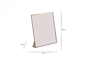 A rectangular tabletop mirror with a slim gold frame (35 cm tall, 30 cm wide, 5 cm stand) stands upright on a white background—perfect placed beside nkuku’s Karuma Ceramic Mug - Small (Set of 2) or other handmade mugs.