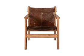 The Dalibar Leather Lounger - Tan by nkuku features a contemporary front-facing design with straight acacia wood arms and legs, and a vintage-style worn brown buffalo leather sling seat and backrest. Shown against a plain white background.