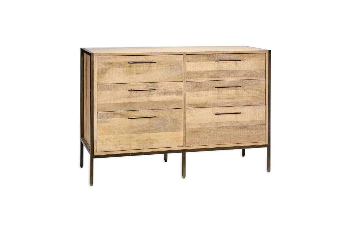 The Dasai Mango Wood Chest of Drawers by nkuku features six spacious drawers in two columns, a natural light mango wood finish, slim metal handles, and stands on four thin black legs with a matching metal frame around the base.