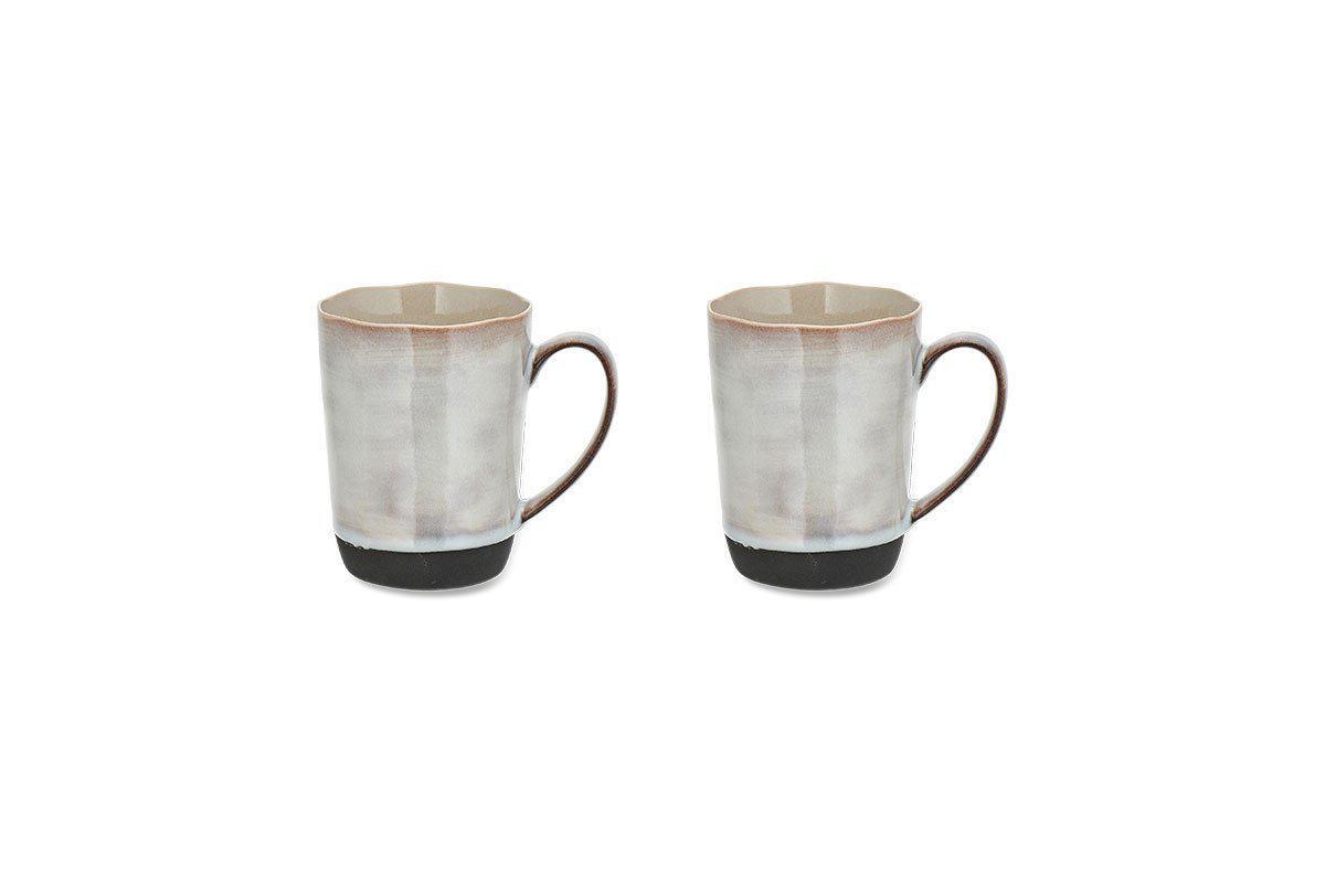 Set of two matching Edo Mug - Large - Slate by nkuku, featuring a rustic reactive glaze in pearlescent grey-white, dark brown handles, and matte black bases. Tapered shape with slightly flared rims on a white background.