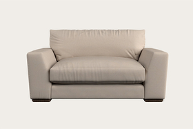 Introducing the Guddu Large Right Hand Chaise Sofa by Nkuku in Brera Linen Indigo—a modern handcrafted piece showcasing British craftsmanship. This sofa features wide, square armrests, a thick seat cushion, and a plush back cushion, all set in a minimalist design with low rectangular legs against a plain, light background.