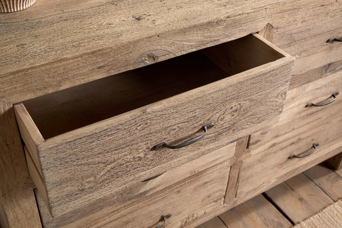 The Iya Reclaimed Wood Chest of Drawers - Natural - Large by nkuku offers rustic charm and practical storage, featuring spacious drawers for a stylish and functional addition to any space.